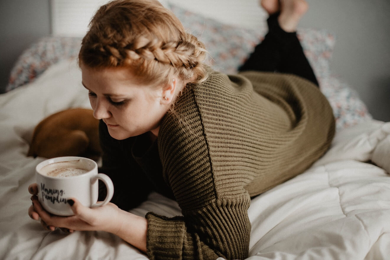 Pensive young woman lounging at home