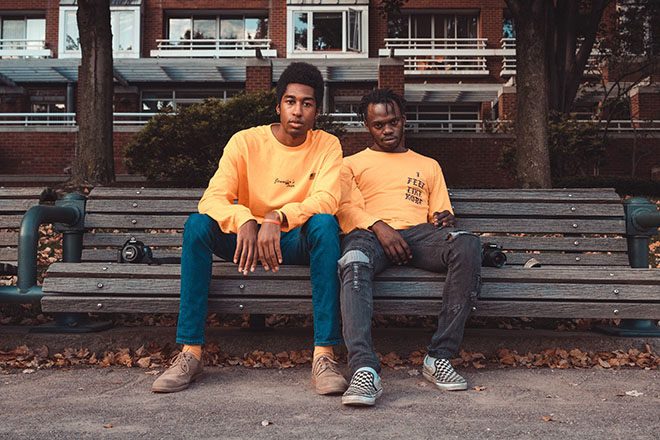 Two friends sitting on bench