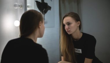 woman staring at herself in the mirror