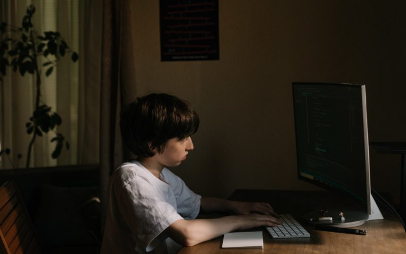 Kid staring at the computer concerned about Cyberbullying
