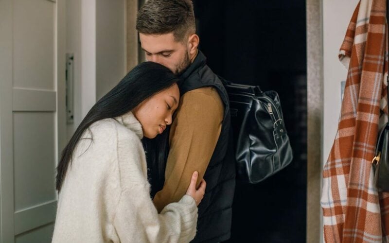 woman holding onto male partner's arm