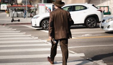 man walking across street