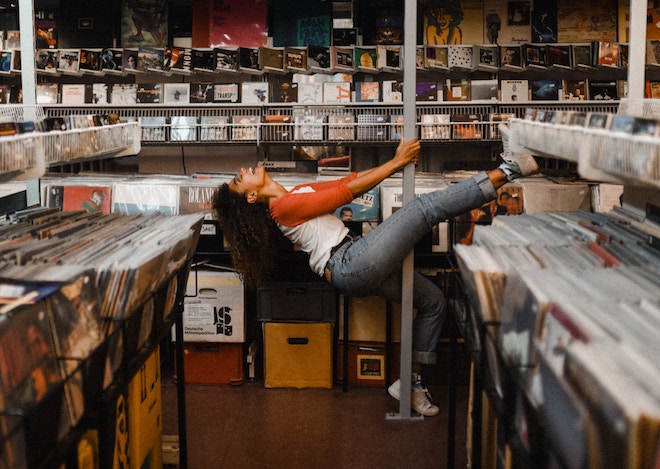 A woman dances in a record store