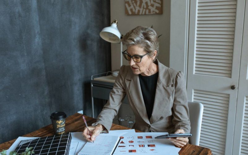 An old lady taking notes on a notepad