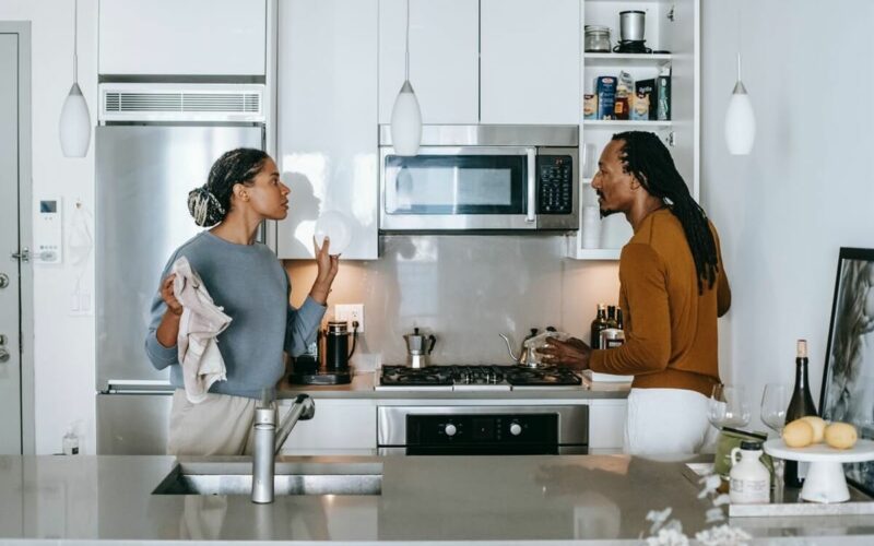 man and woman arguing in kitchen