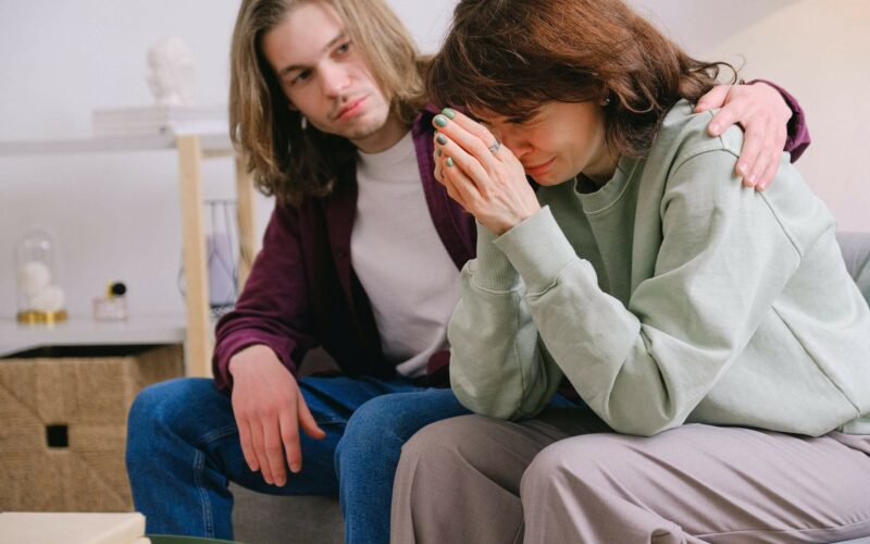 man comforting woman