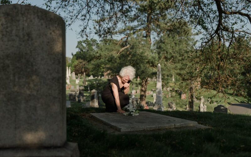 woman bending over grave