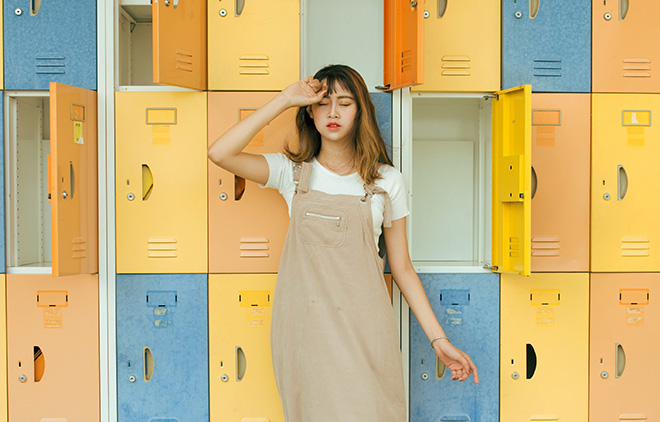 A teen stands by lockers at school