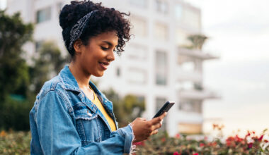 woman-looking-at-phone-in-city