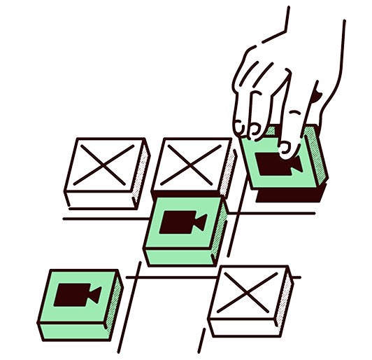 Hand placing a green block with a video camera icon on a grid of similar blocks, some marked with X.
