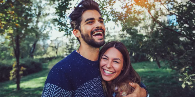 Couple laughing and holding each other