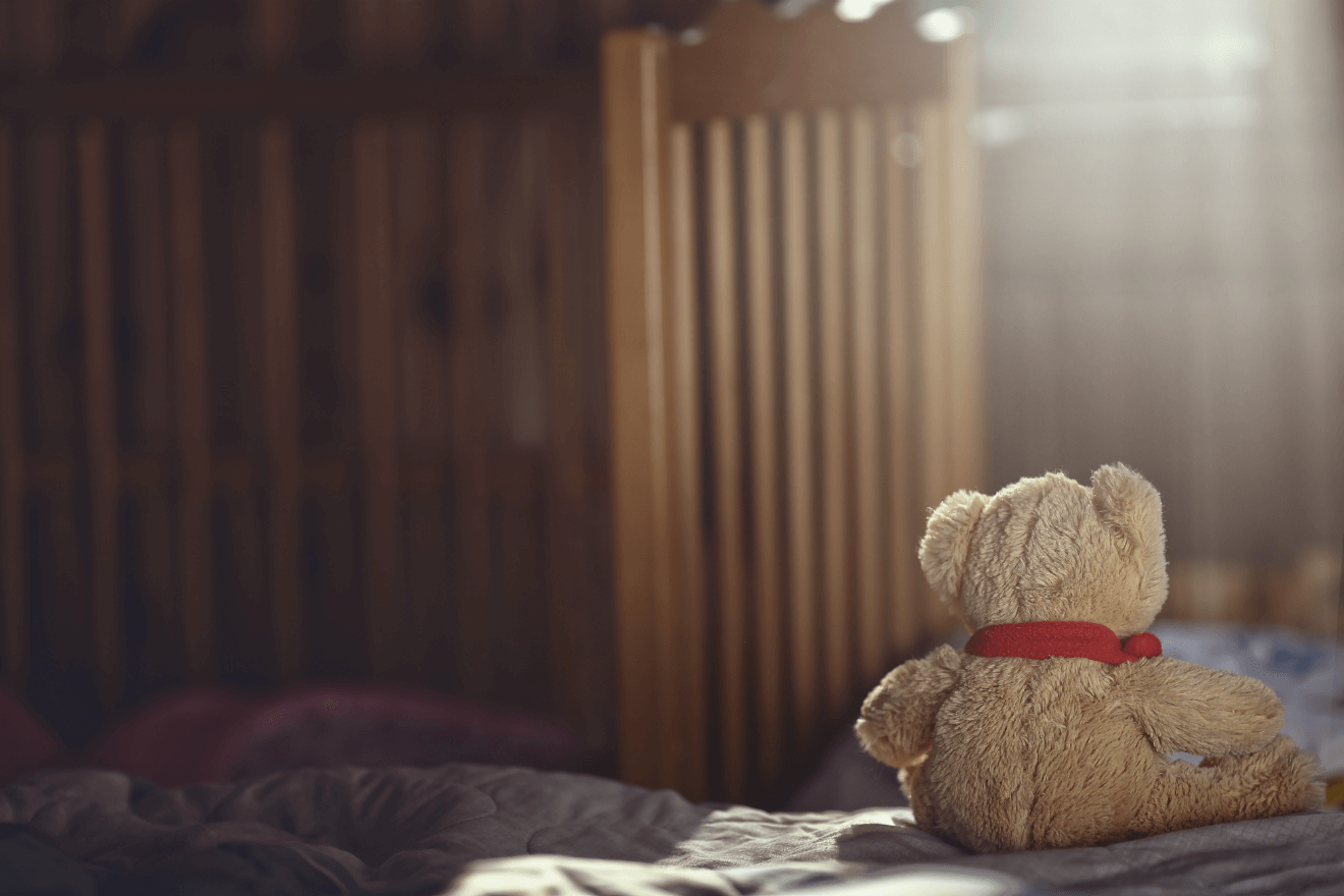 teddy bear in empty child room