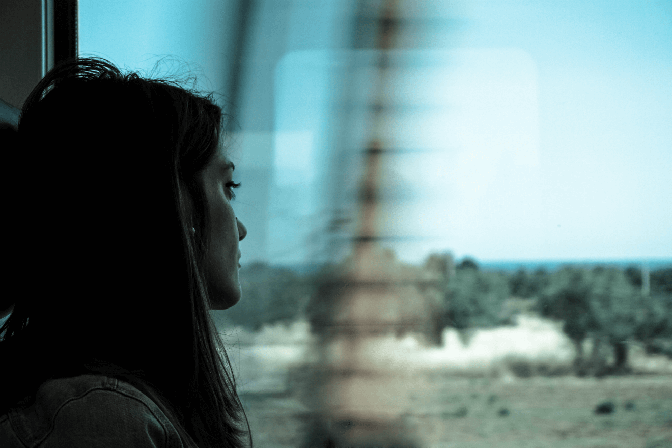woman traveling on train blurred view